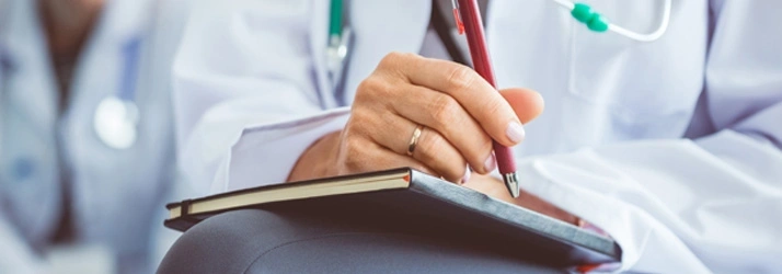 Doctor Writing Patient Notes