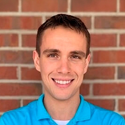 Professional Headshot Against Brick Wall