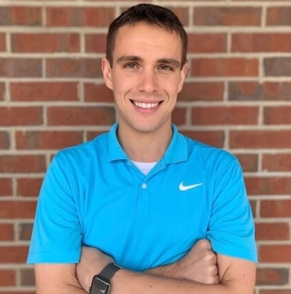 Professional Headshot Against Brick Wall